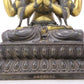 A serene gilt bronze four-armed Guanyin statue