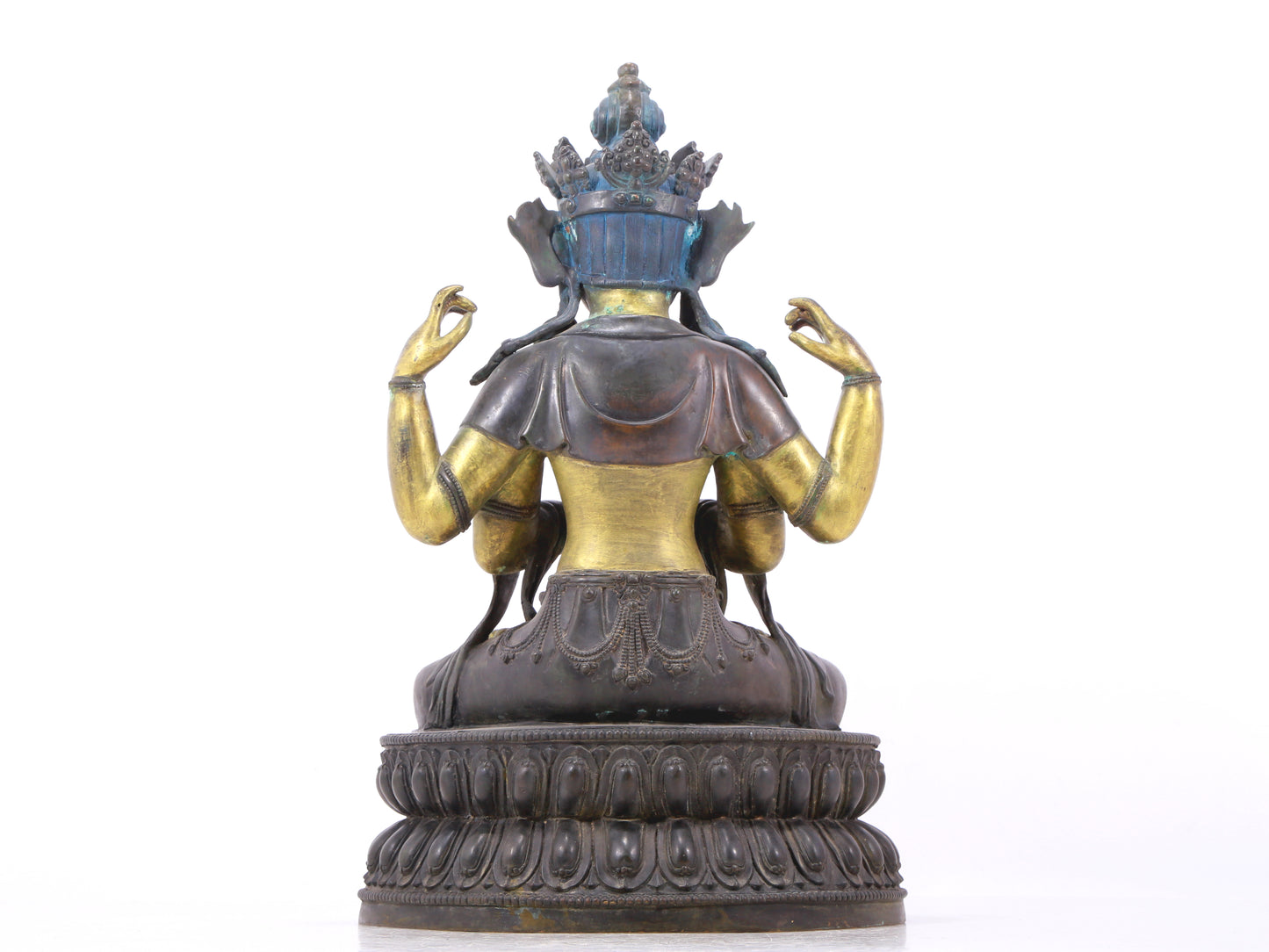 A serene gilt bronze four-armed Guanyin statue