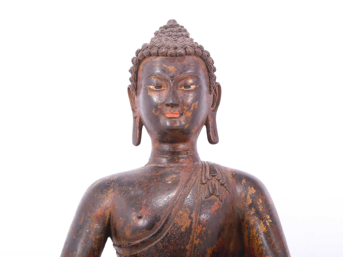 A serene gilt bronze statue of Gautama Buddha