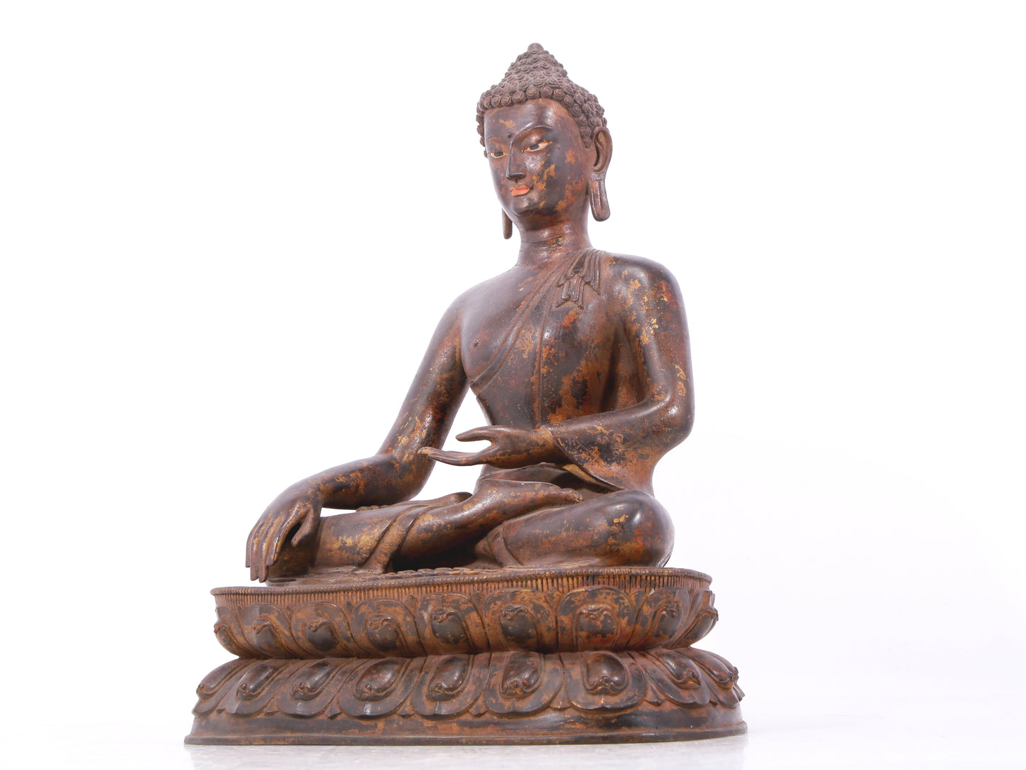 A serene gilt bronze statue of Gautama Buddha