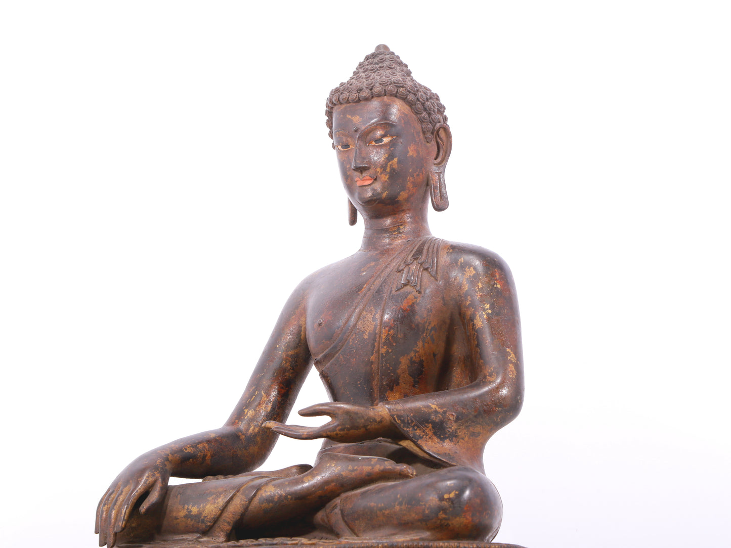 A serene gilt bronze statue of Gautama Buddha