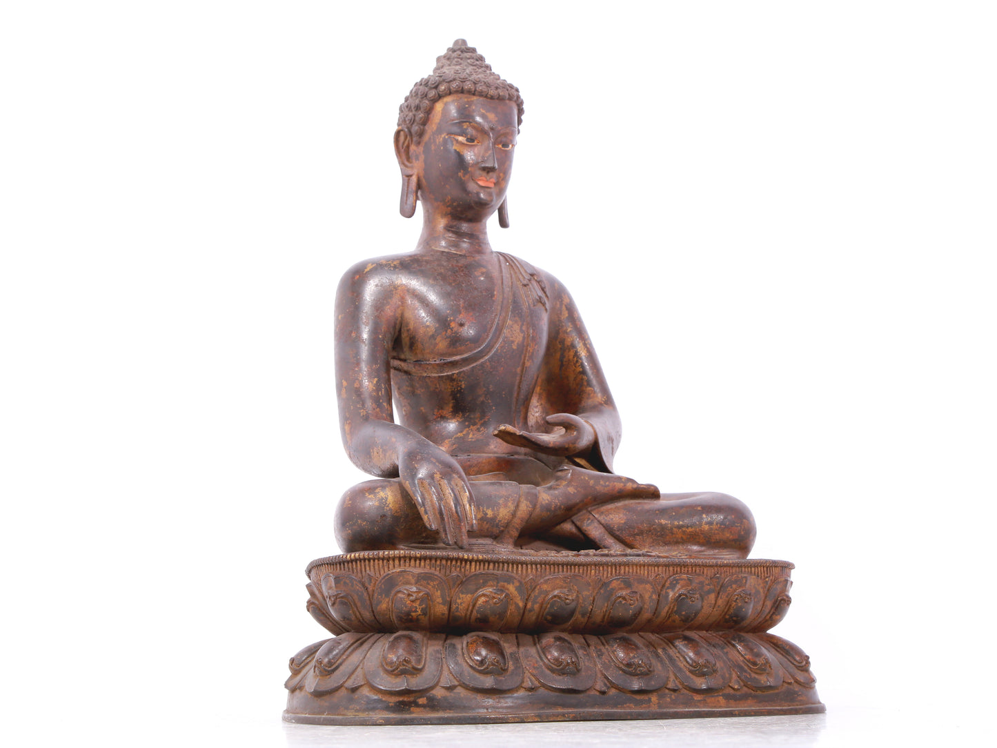 A serene gilt bronze statue of Gautama Buddha