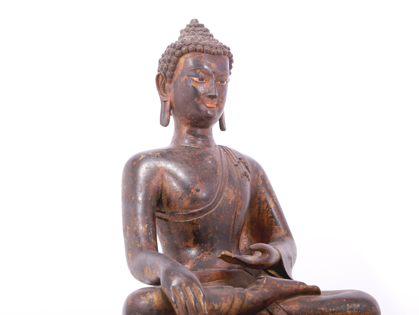 A serene gilt bronze statue of Gautama Buddha