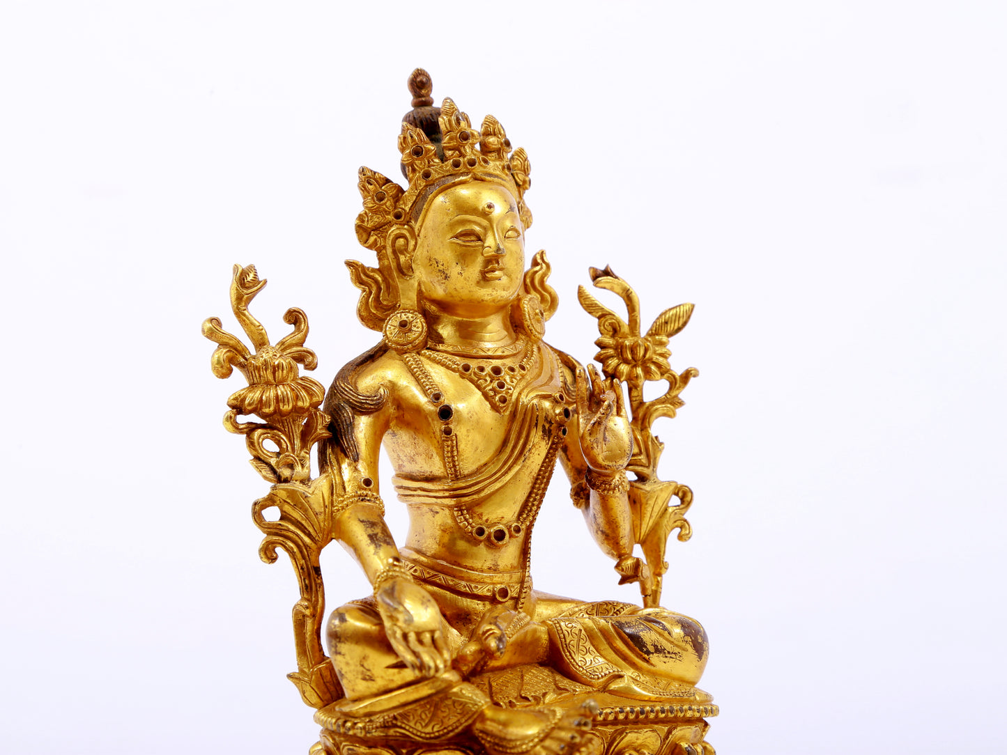 A serene gilt bronze green Tara statue