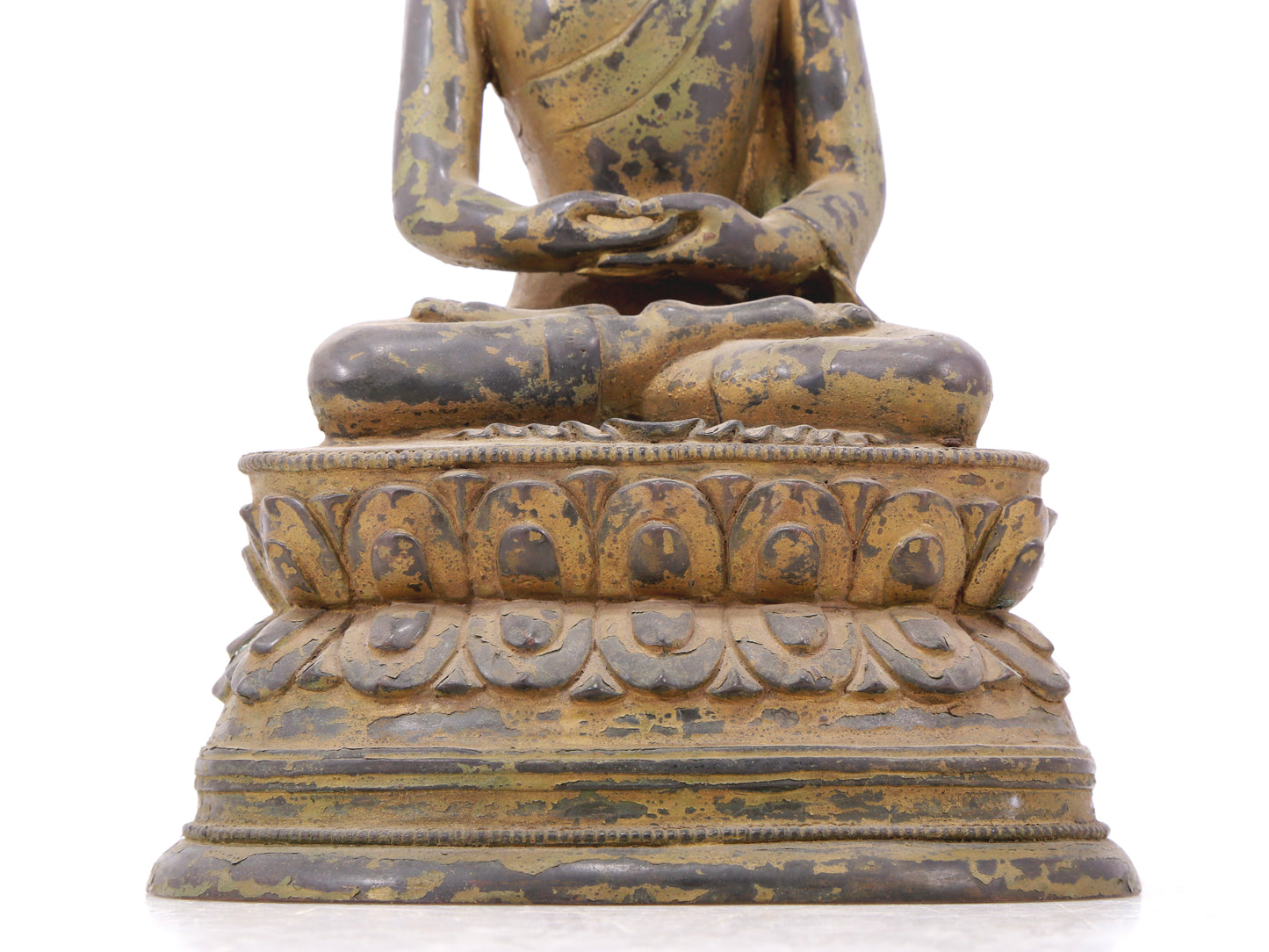 A serene gilt bronze statue of Gautama Buddha