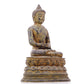 A serene gilt bronze statue of Gautama Buddha