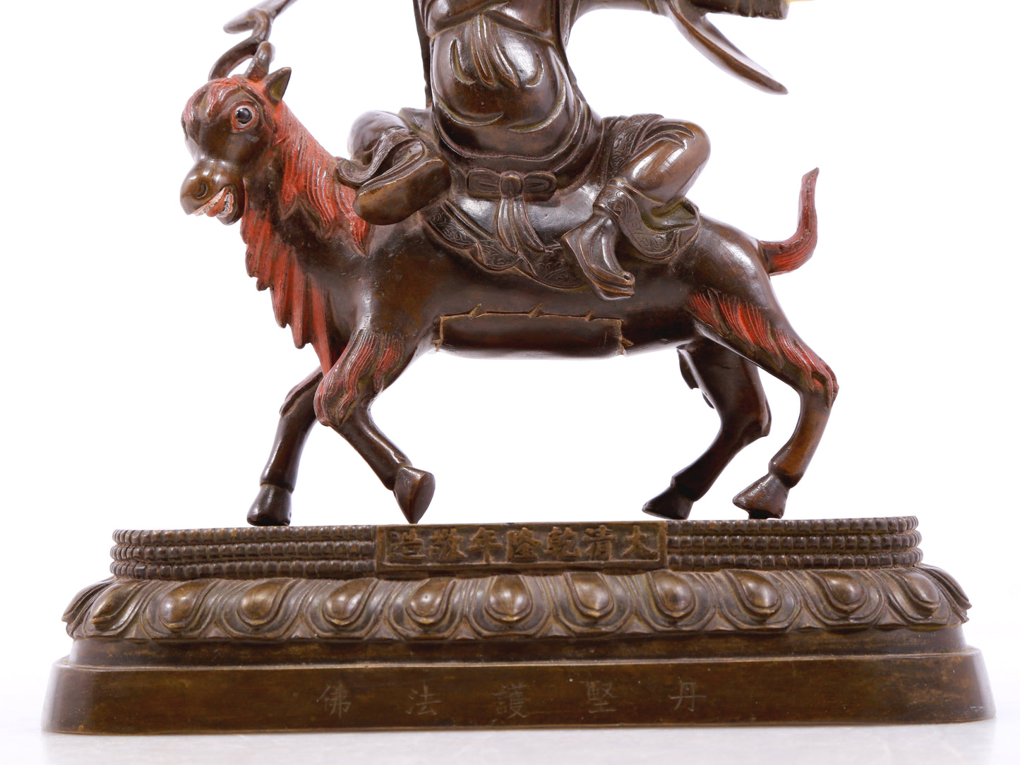 A serene gilt bronze protector statue