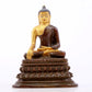 A serene gilt bronze statue of Gautama Buddha