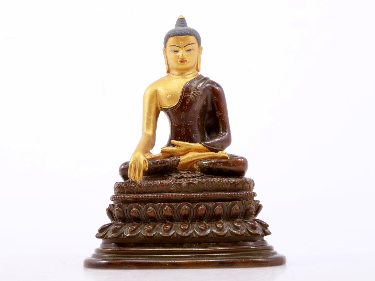 A serene gilt bronze statue of Gautama Buddha