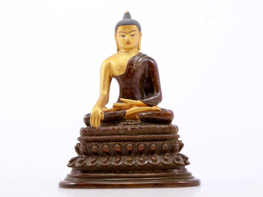 A serene gilt bronze statue of Gautama Buddha