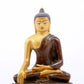 A serene gilt bronze statue of Gautama Buddha