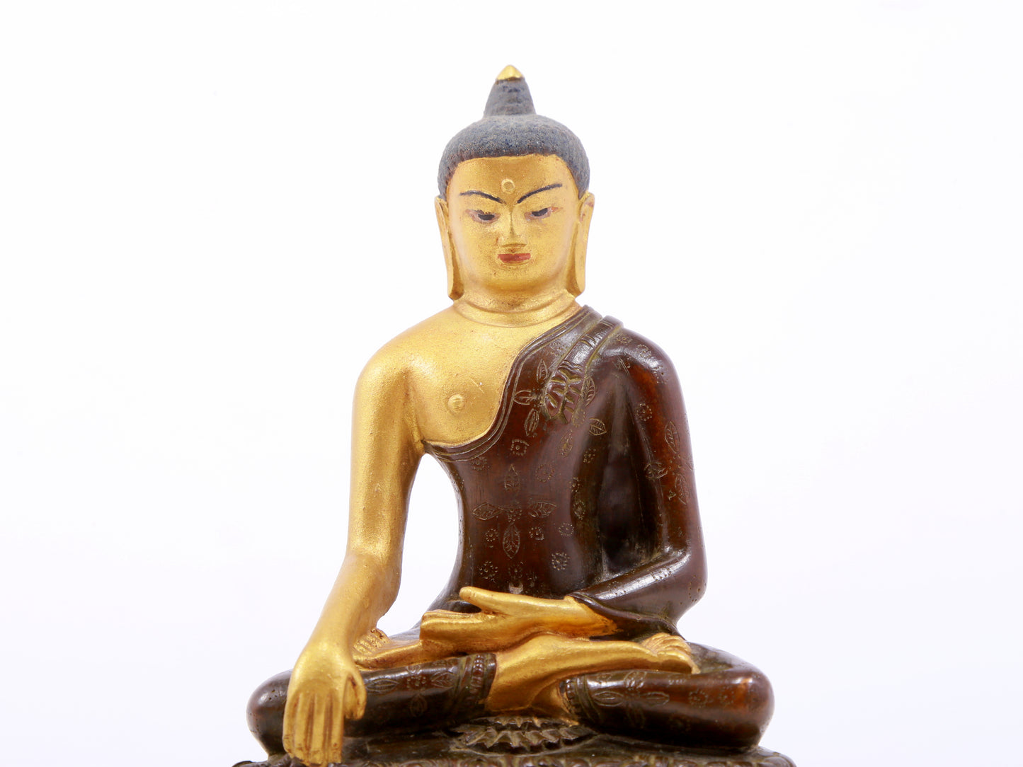 A serene gilt bronze statue of Gautama Buddha