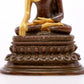 A serene gilt bronze statue of Gautama Buddha