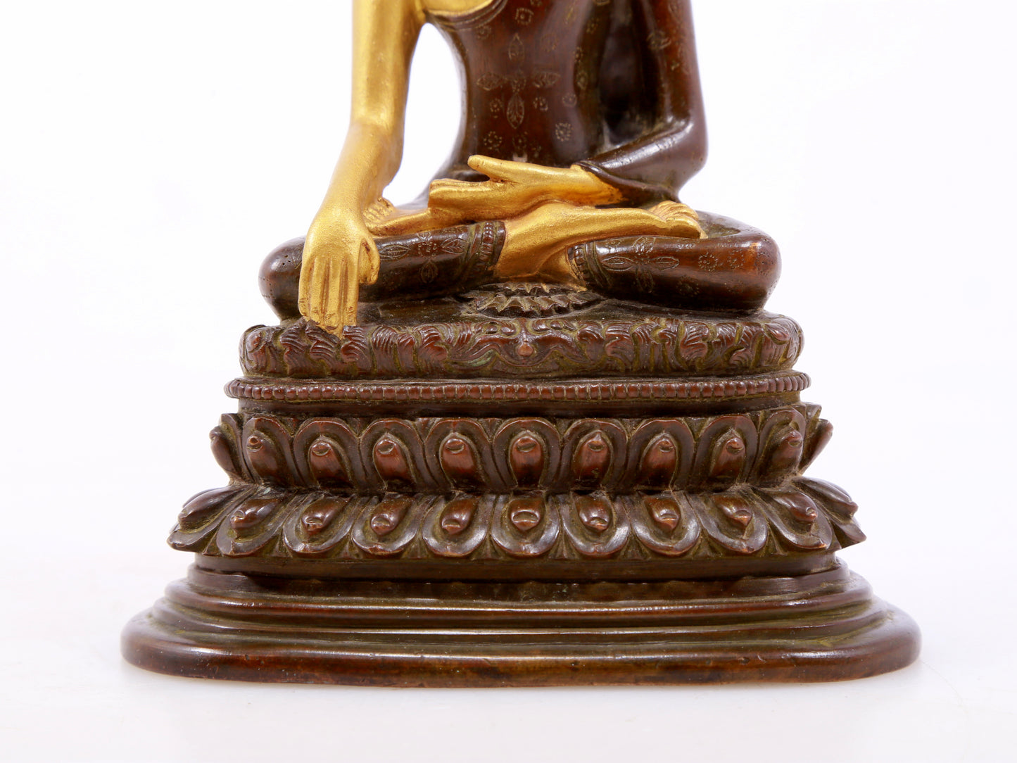 A serene gilt bronze statue of Gautama Buddha