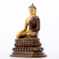 A serene gilt bronze statue of Gautama Buddha