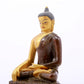 A serene gilt bronze statue of Gautama Buddha