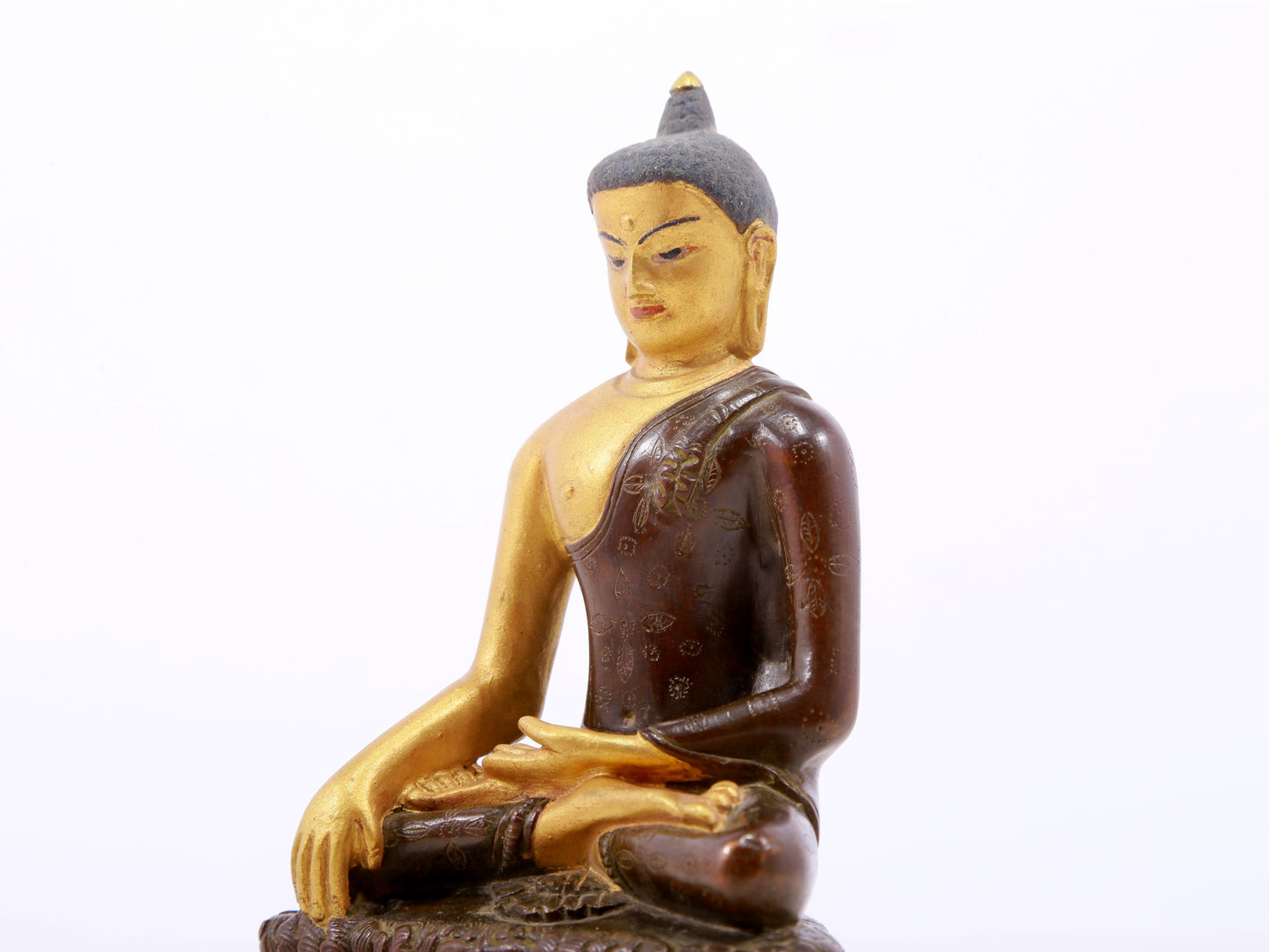 A serene gilt bronze statue of Gautama Buddha