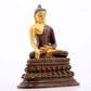 A serene gilt bronze statue of Gautama Buddha