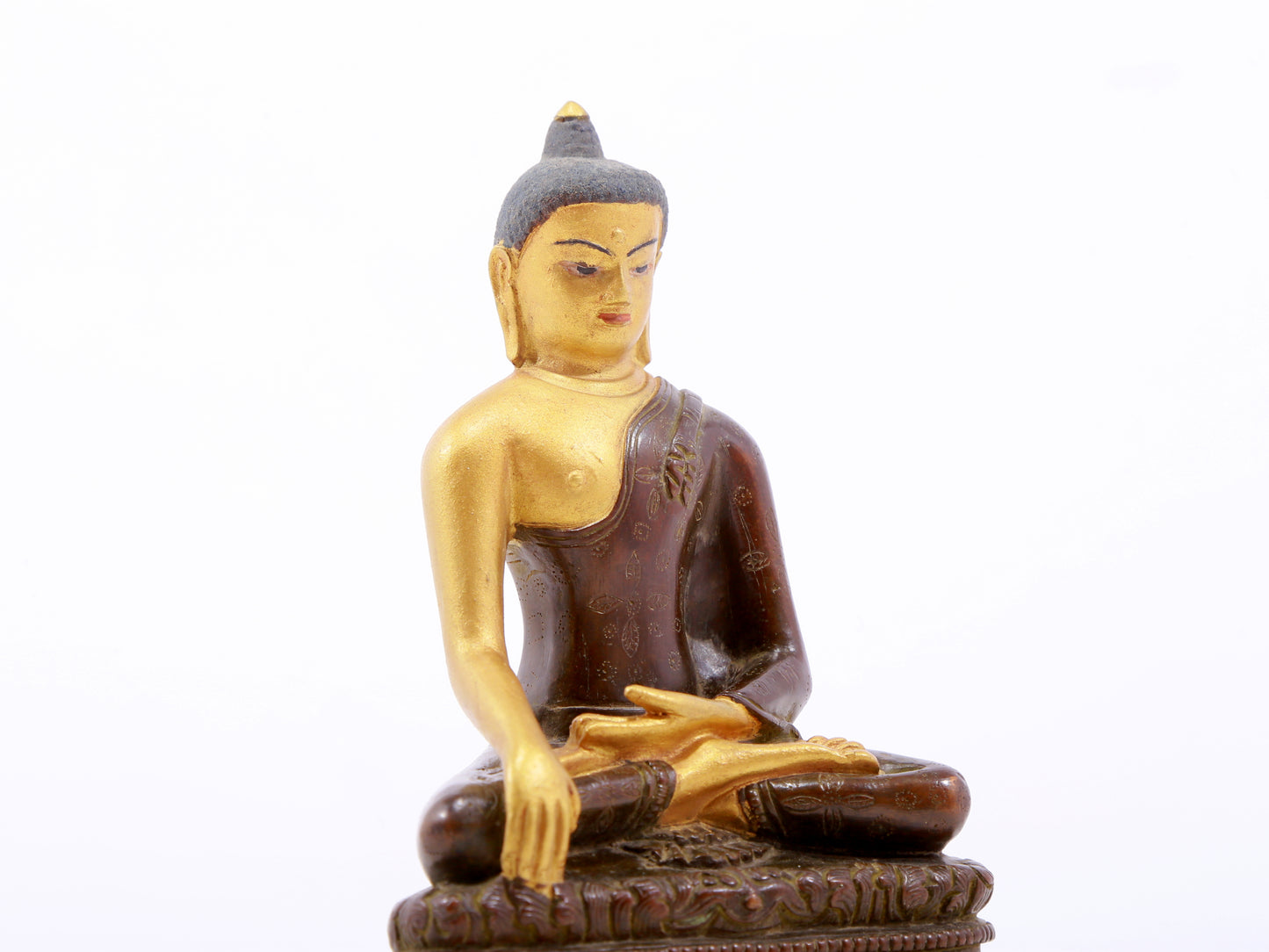 A serene gilt bronze statue of Gautama Buddha