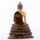 A serene gilt bronze statue of Gautama Buddha