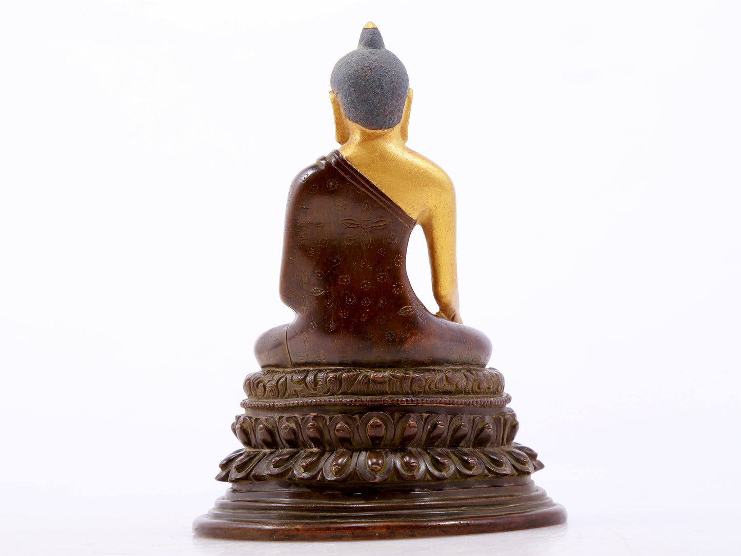 A serene gilt bronze statue of Gautama Buddha