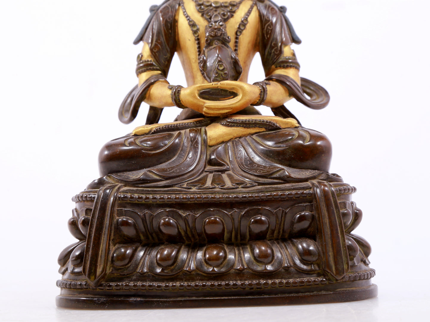 A serene gilt bronze statue of Amitayus Buddha