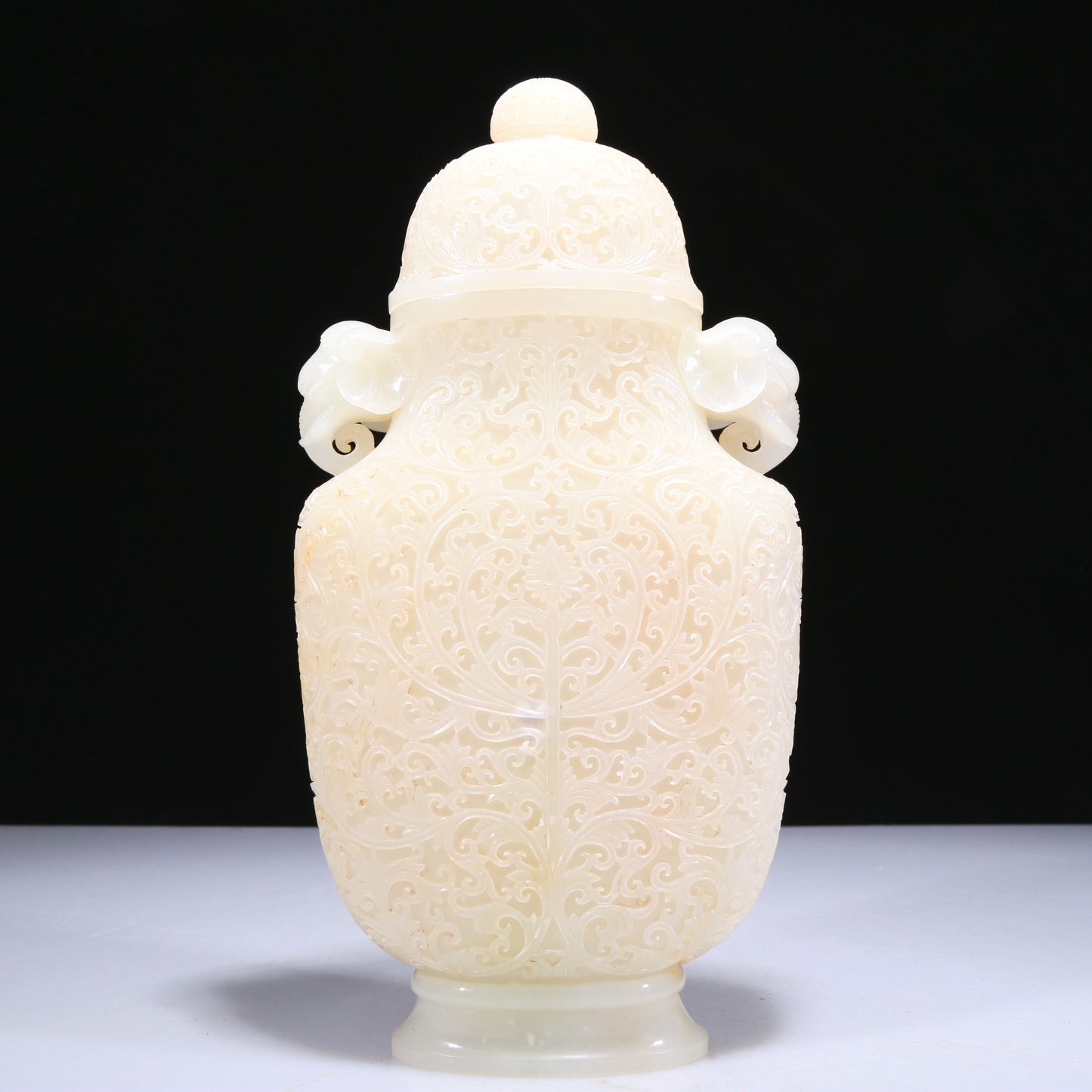 An Elaborate White Jade 'Scrolling Lotus' Elephant-Handled Vase