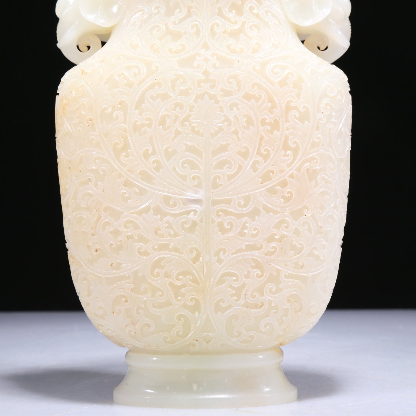 An Elaborate White Jade 'Scrolling Lotus' Elephant-Handled Vase