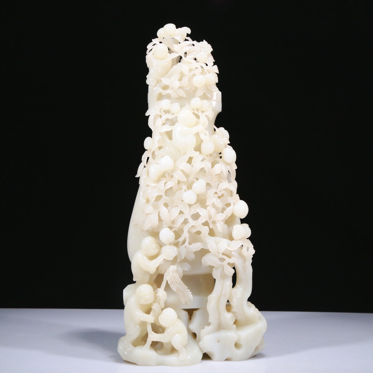 An Elaborate White Jade 'Figures Picking Peaches' Vase With Imperial Poem Inscriptions From Qianlong Period