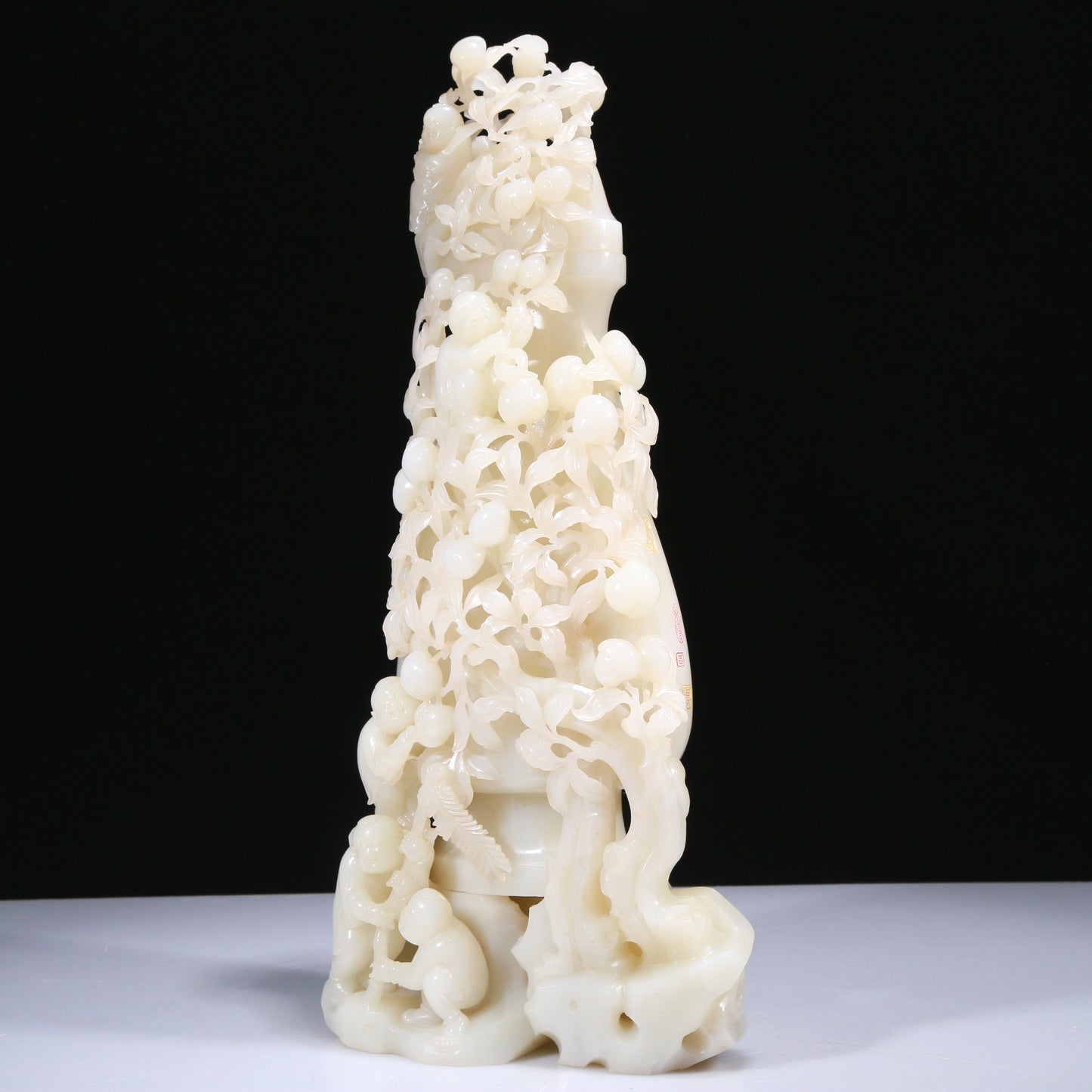 An Elaborate White Jade 'Figures Picking Peaches' Vase With Imperial Poem Inscriptions From Qianlong Period