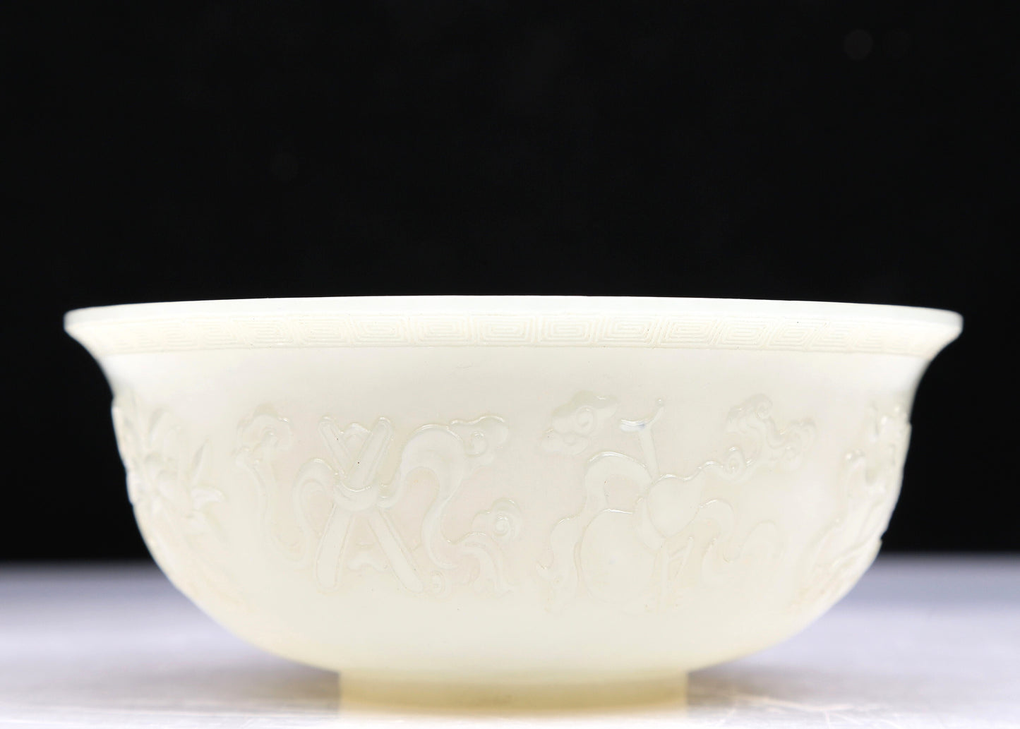 An Excellent White Jade 'Weapons Of The Eight Immortals' Bowl