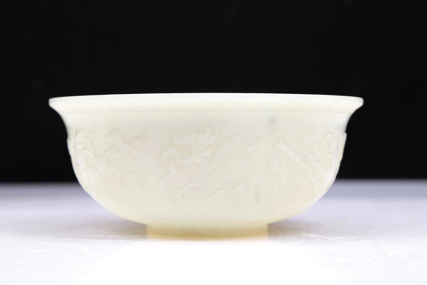 An Excellent White Jade 'Weapons Of The Eight Immortals' Bowl