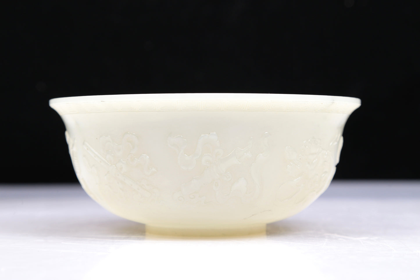 An Excellent White Jade 'Weapons Of The Eight Immortals' Bowl