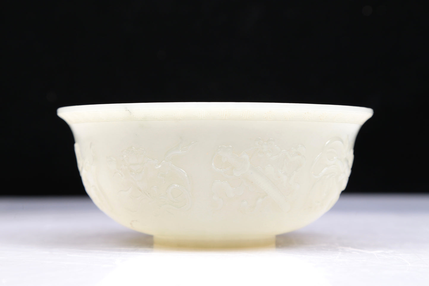 An Excellent White Jade 'Weapons Of The Eight Immortals' Bowl