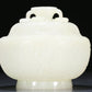 An Exquisite White Jade 'Weapons Of The Eight Immortals' Jar And Cover