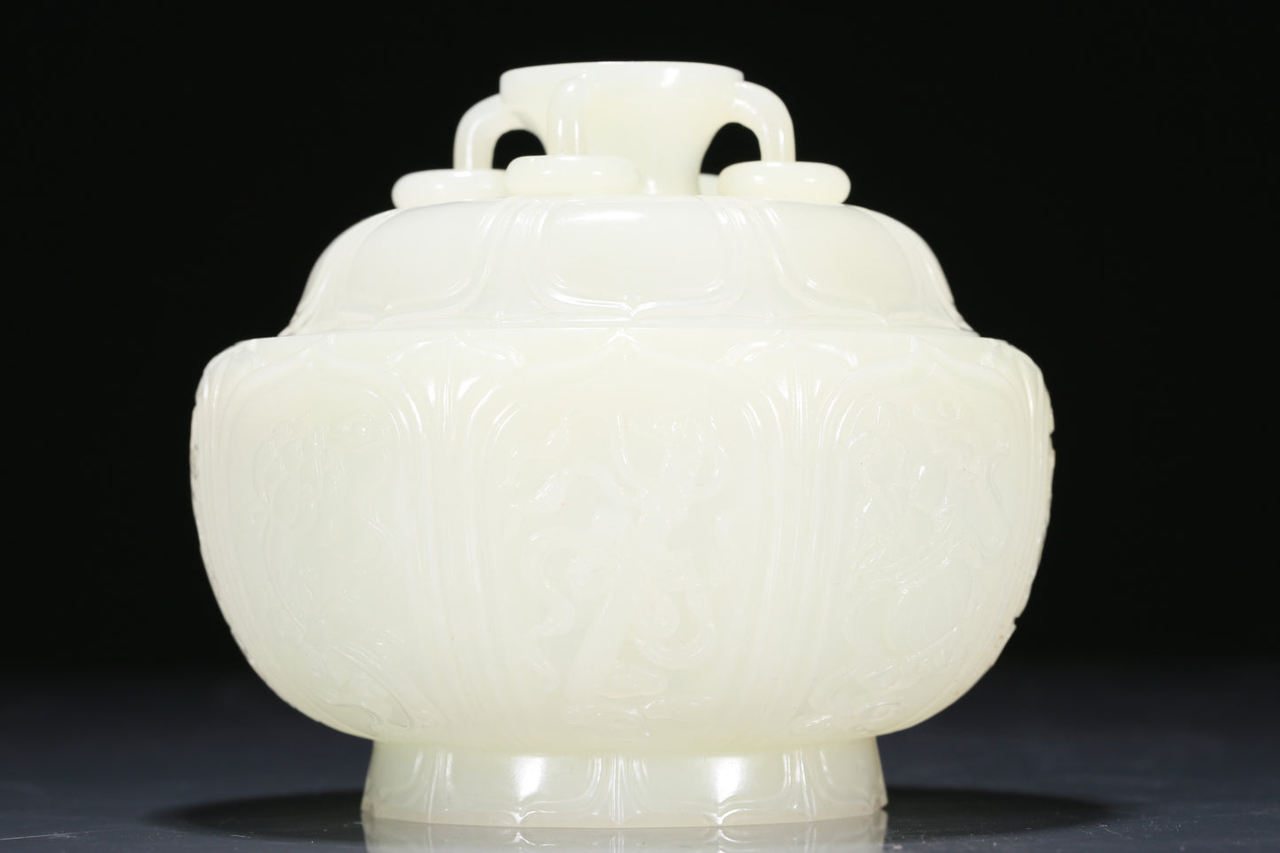 An Exquisite White Jade 'Weapons Of The Eight Immortals' Jar And Cover