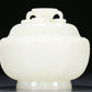 An Exquisite White Jade 'Weapons Of The Eight Immortals' Jar And Cover