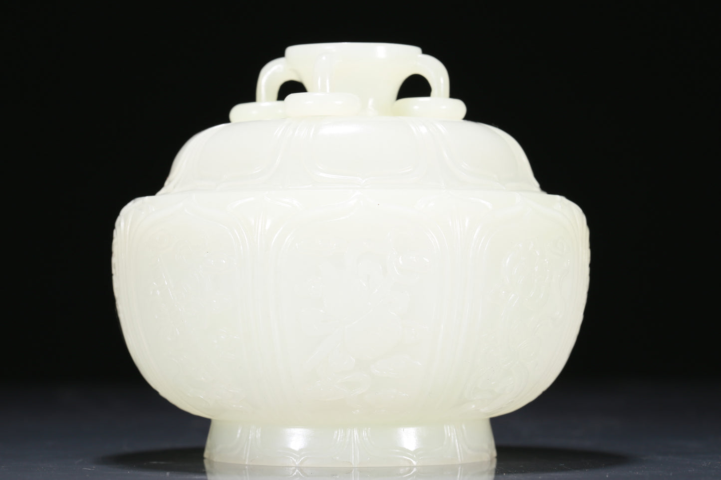 An Exquisite White Jade 'Weapons Of The Eight Immortals' Jar And Cover