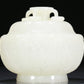 An Exquisite White Jade 'Weapons Of The Eight Immortals' Jar And Cover