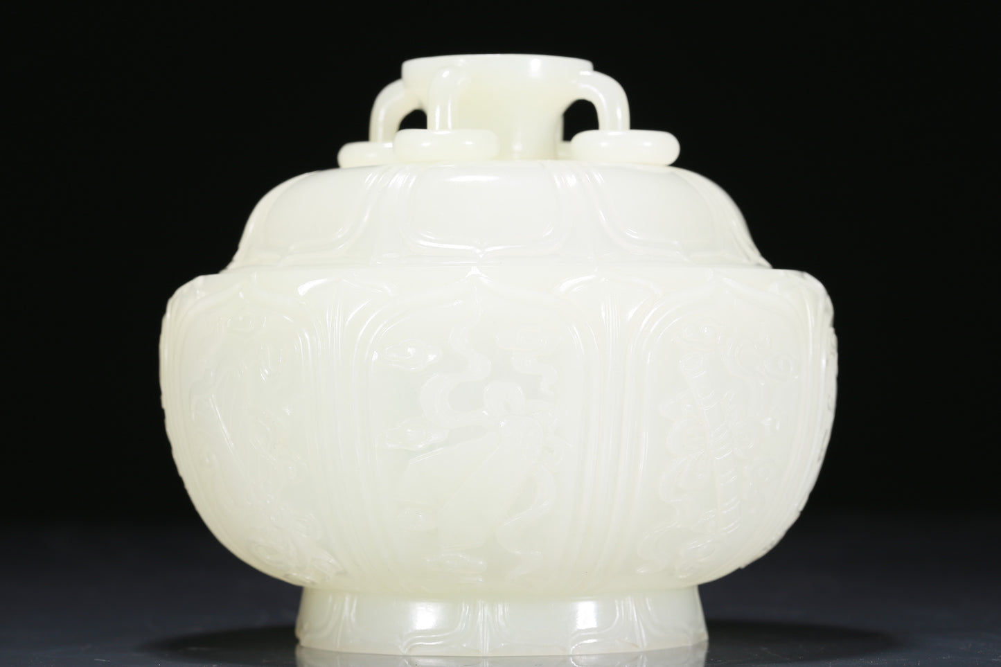 An Exquisite White Jade 'Weapons Of The Eight Immortals' Jar And Cover