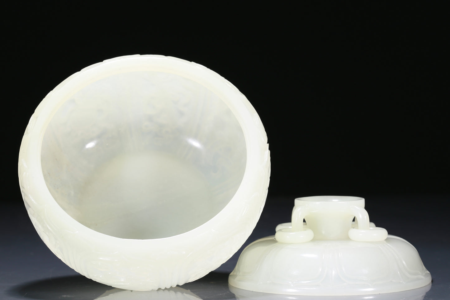 An Exquisite White Jade 'Weapons Of The Eight Immortals' Jar And Cover