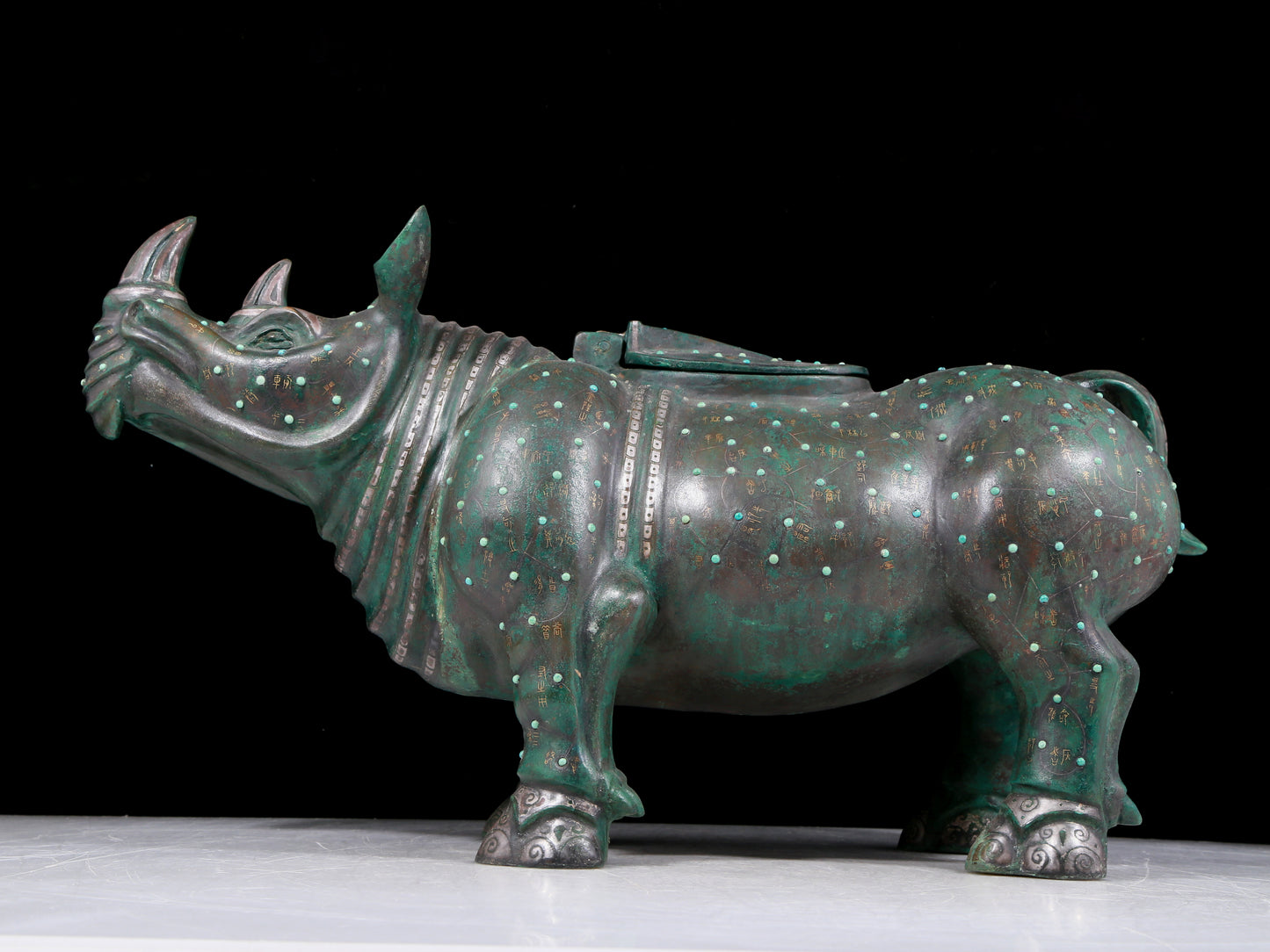 A precious bronze rhinoceros jar inlaid with gold and silver