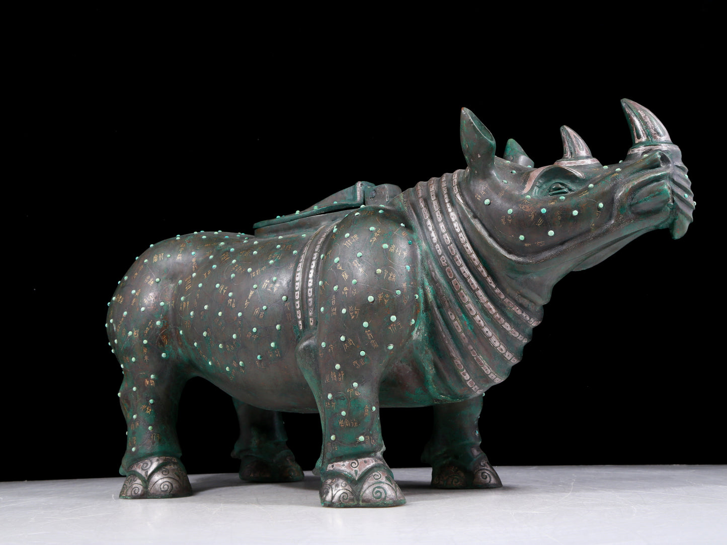 A precious bronze rhinoceros jar inlaid with gold and silver