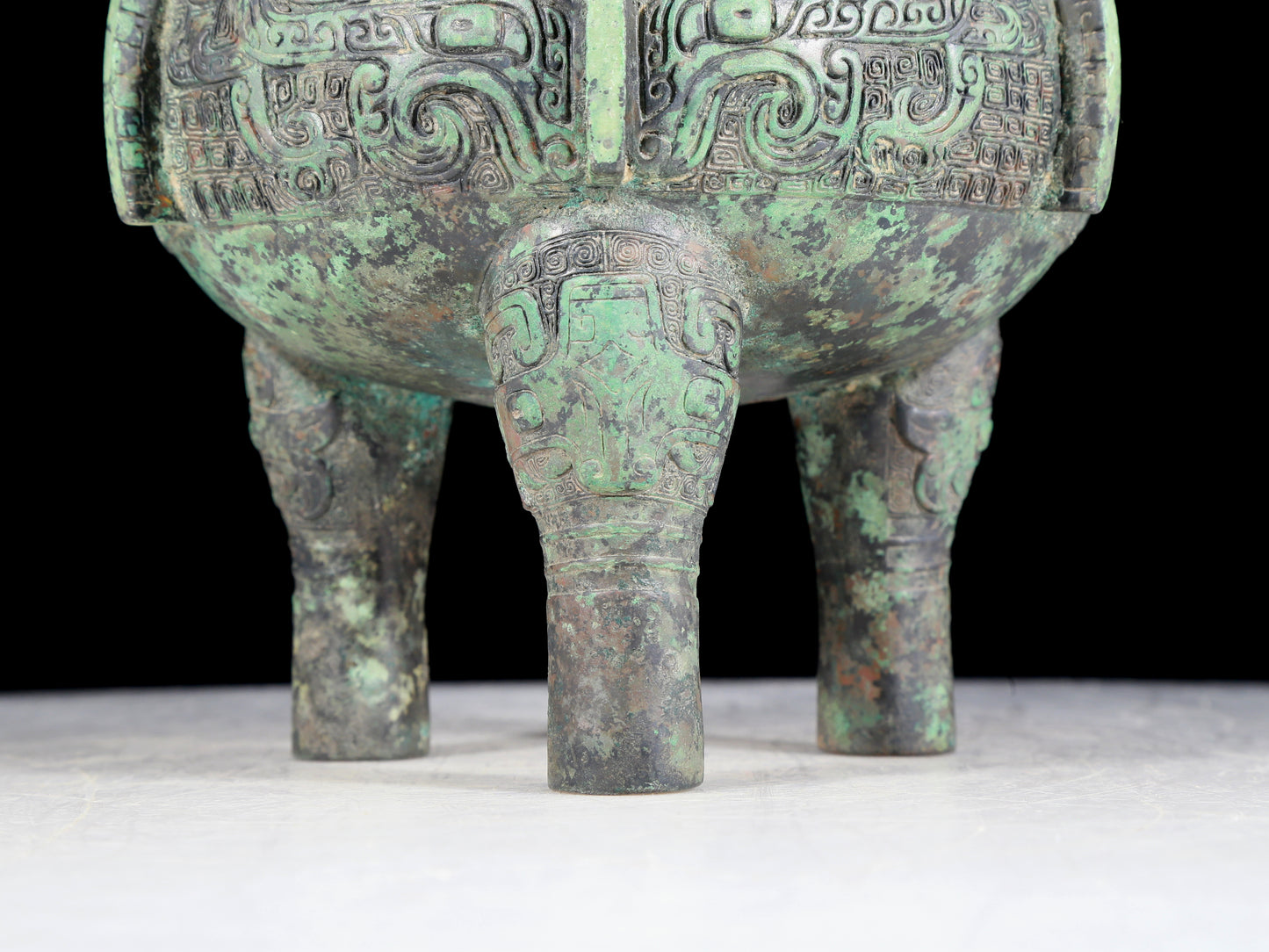 A precious bronze animal-faced two-eared and tripod furnace