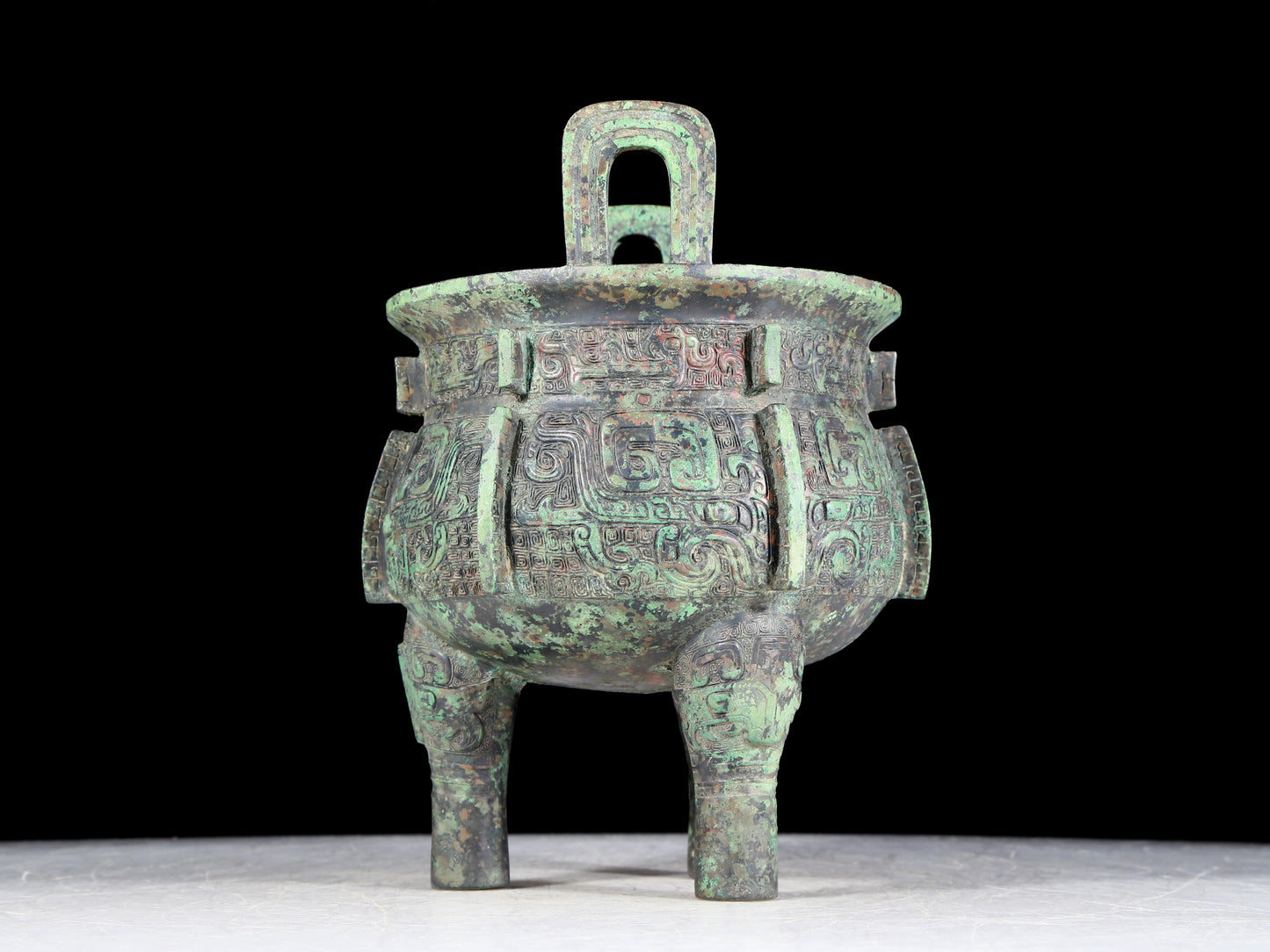 A precious bronze animal-faced two-eared and tripod furnace