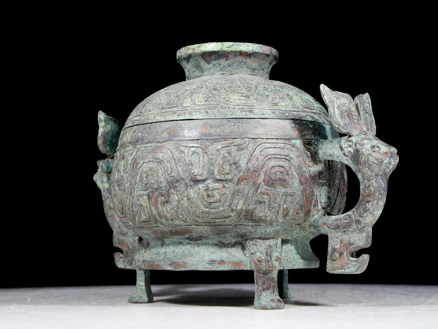 A precious bronze two-eared tripod furnace with auspicious animal patterns and a lid