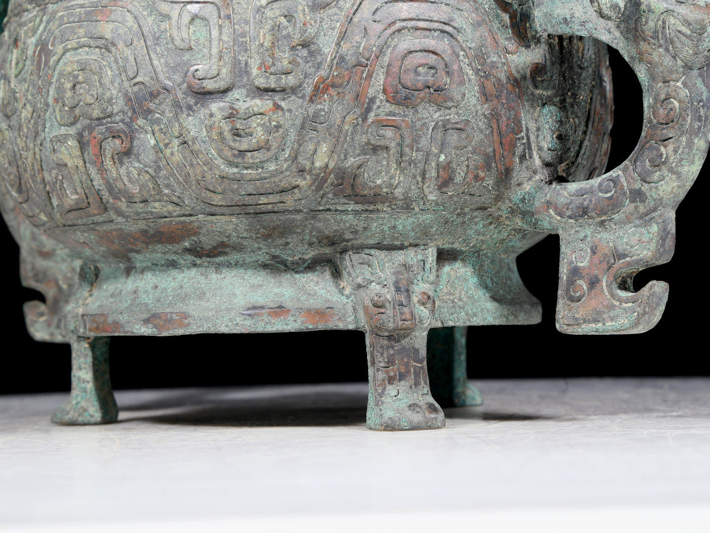 A precious bronze two-eared tripod furnace with auspicious animal patterns and a lid