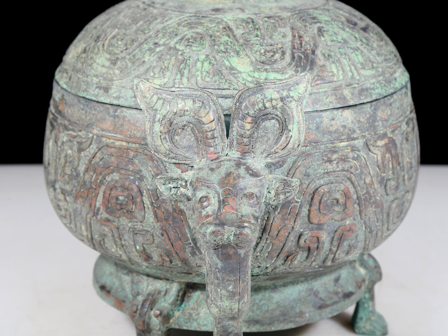 A precious bronze two-eared tripod furnace with auspicious animal patterns and a lid