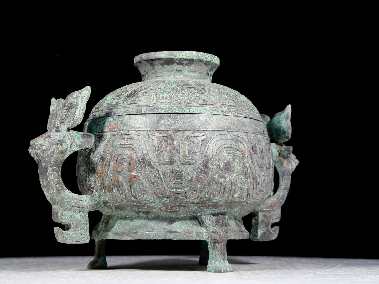 A precious bronze two-eared tripod furnace with auspicious animal patterns and a lid