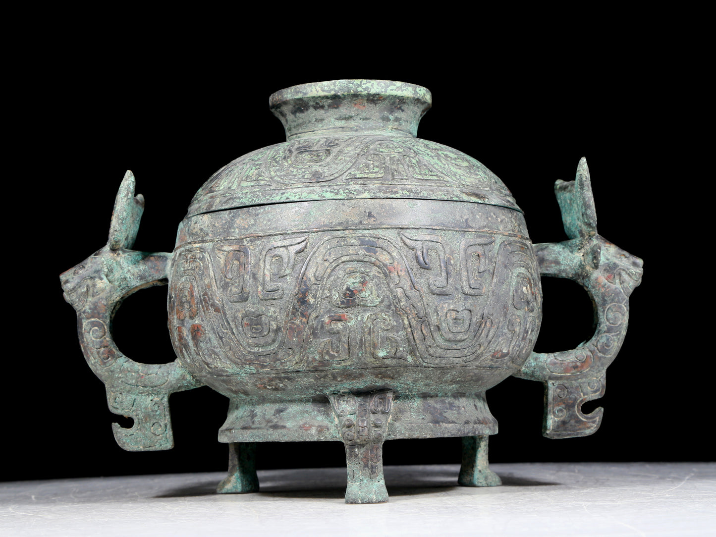 A precious bronze two-eared tripod furnace with auspicious animal patterns and a lid